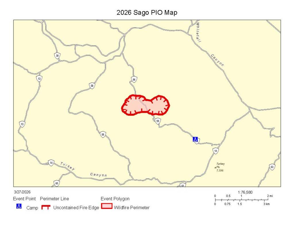 A map indicating the 2026 Sago PIO area, showing a polygon in red against a pale yellow background, hashmarks indicating an uncontained fire edge, and the firefighter's spike camp location with highways and geographic labels.